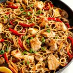 "Ingredients for Chicken Lo Mein recipe laid out on kitchen counter.